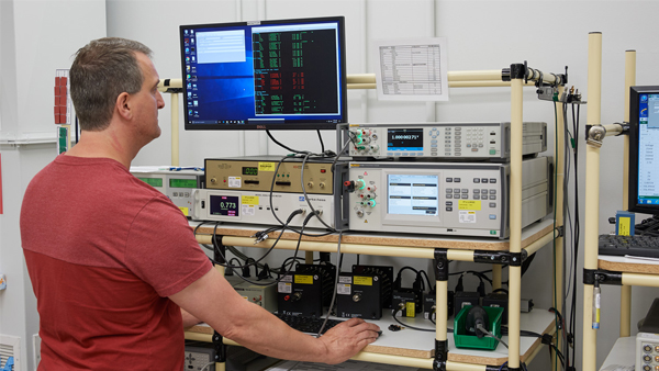 Technician Using a Fluke 8588A in a Calibration Lab